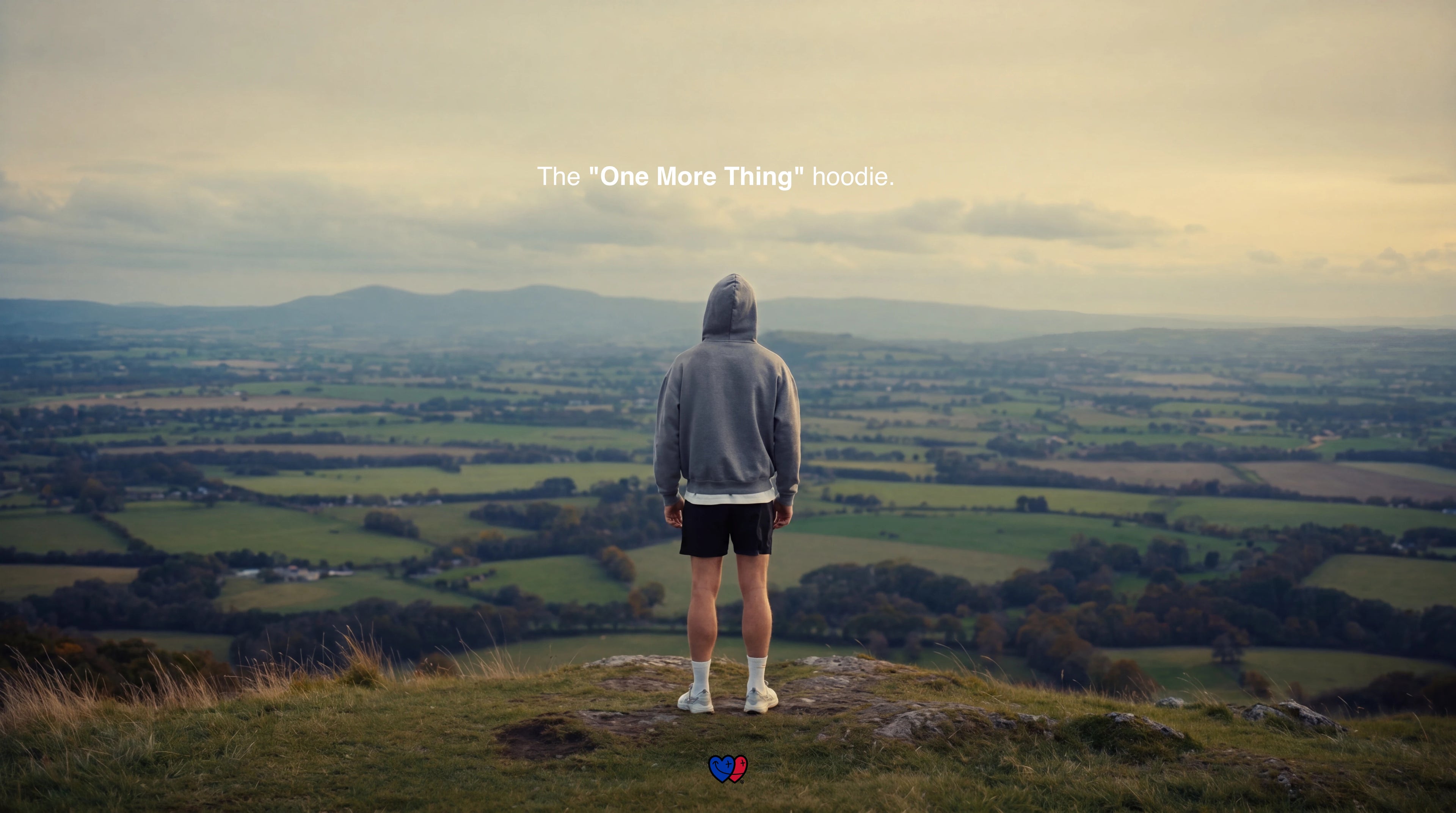 Person standing on a hill overlooking a vast landscape with text overlay.